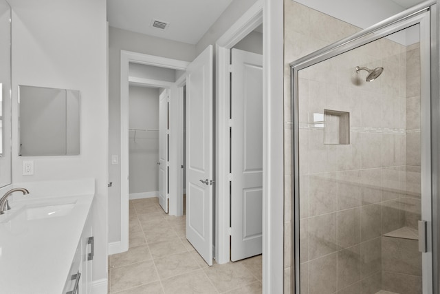 bathroom featuring vanity, tile patterned floors, and an enclosed shower