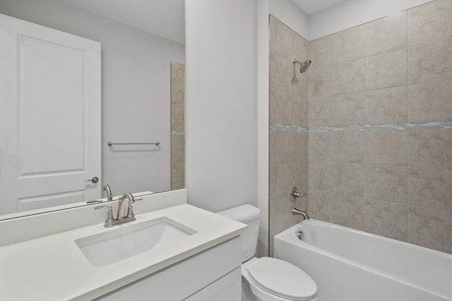 full bathroom with vanity, toilet, and tiled shower / bath