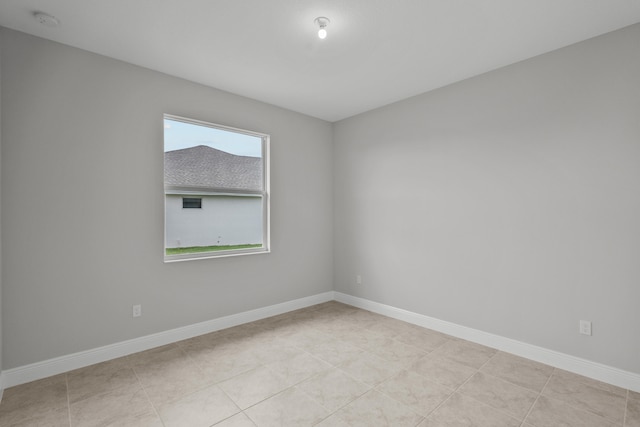 spare room featuring light tile patterned floors