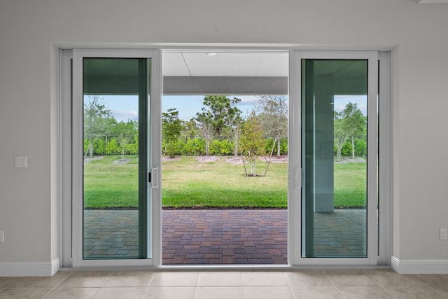 doorway to outside with a healthy amount of sunlight and light tile patterned flooring