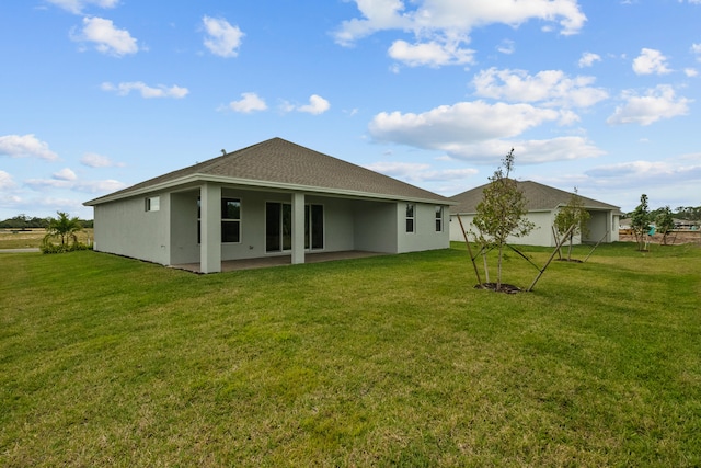 back of property with a patio and a yard