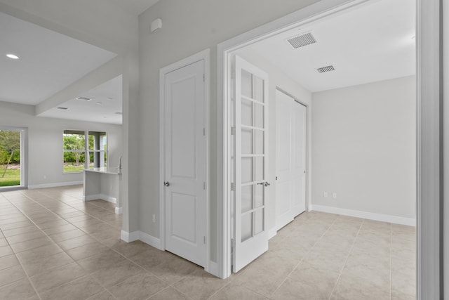 hallway featuring light tile patterned floors