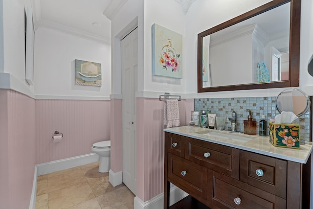 bathroom with tasteful backsplash, tile patterned floors, ornamental molding, vanity, and toilet