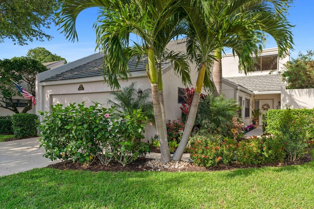 view of front facade with a garage and a front yard