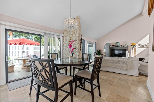 dining space featuring high vaulted ceiling and a chandelier