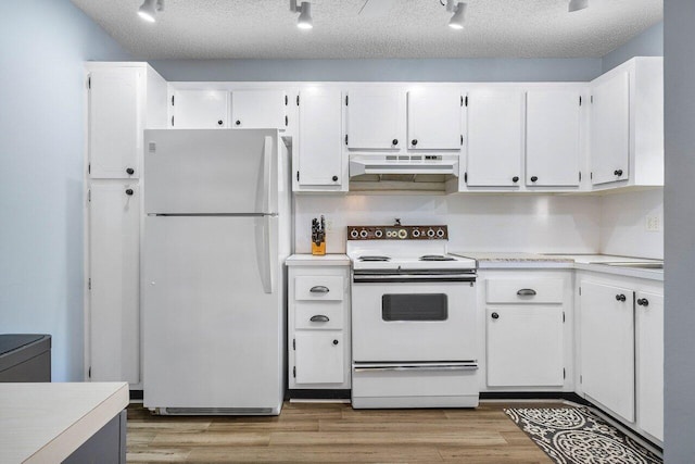 kitchen featuring white cabinetry, light wood-type flooring, a textured ceiling, and white appliances