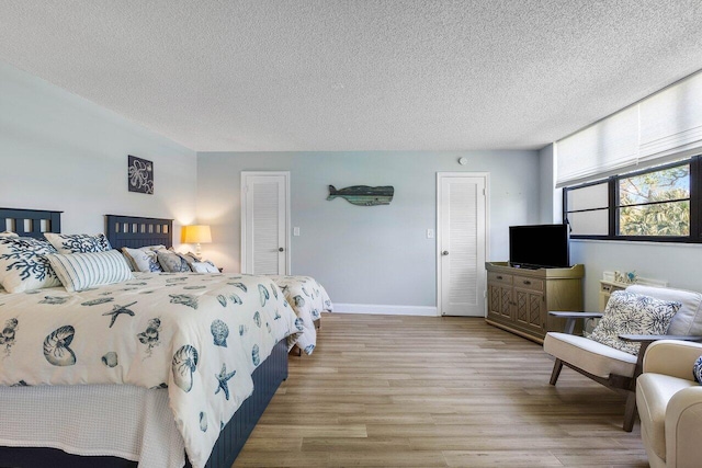 bedroom featuring a textured ceiling and hardwood / wood-style flooring