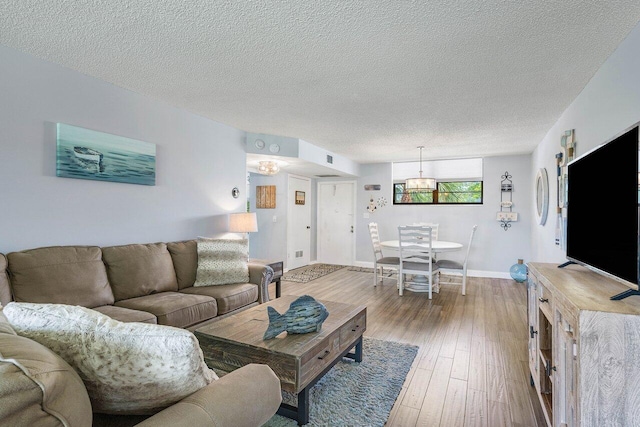 living room with a textured ceiling and hardwood / wood-style flooring