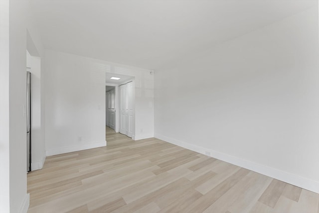 spare room with light hardwood / wood-style floors