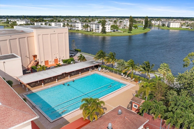 view of pool featuring a water view and a patio