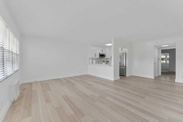 unfurnished living room with light hardwood / wood-style floors