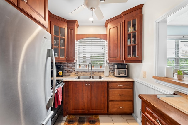 kitchen featuring tasteful backsplash, appliances with stainless steel finishes, sink, and a healthy amount of sunlight