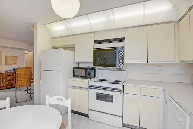 kitchen featuring white cabinets and white appliances