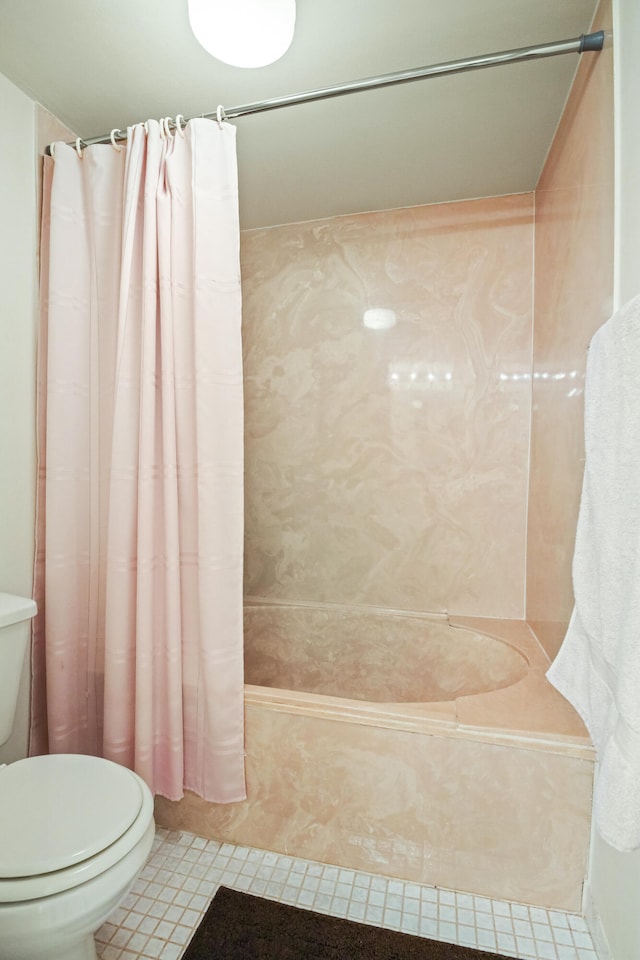 bathroom with toilet, shower / tub combo with curtain, and tile patterned floors