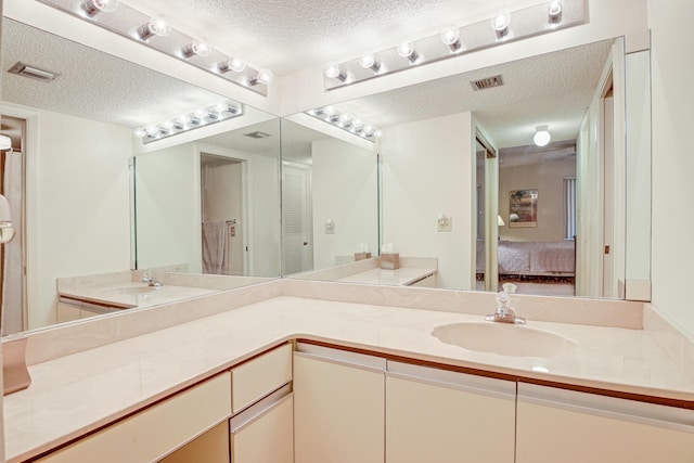 bathroom featuring vanity and a textured ceiling