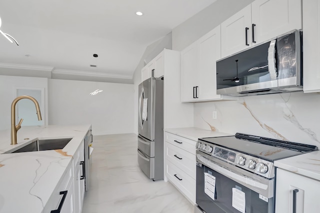 kitchen featuring white cabinets, sink, light stone countertops, and stainless steel appliances