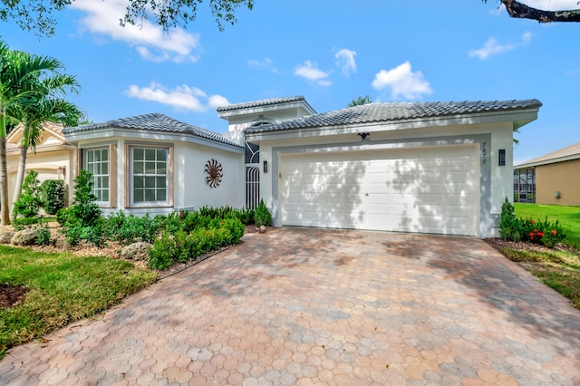 mediterranean / spanish-style home with a garage