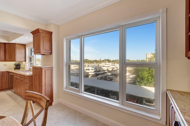 kitchen featuring light tile patterned floors, tasteful backsplash, crown molding, and sink