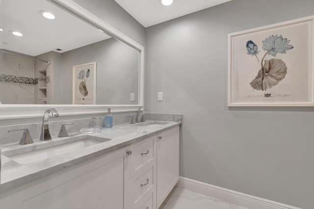 bathroom featuring a shower and vanity