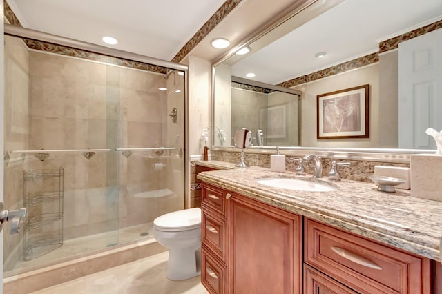 bathroom with vanity, toilet, and walk in shower