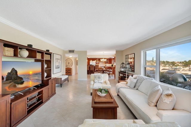 living room featuring a notable chandelier and crown molding