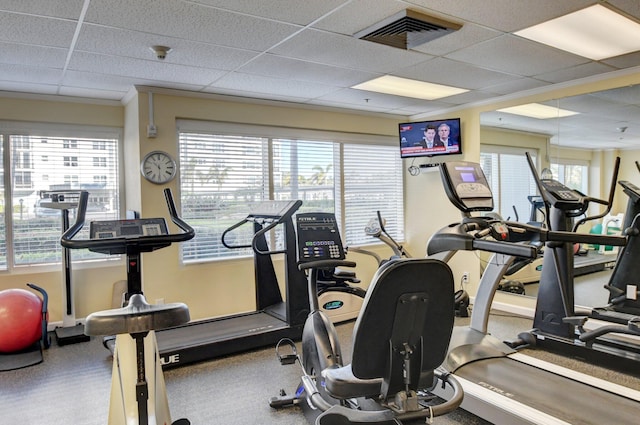 exercise room featuring plenty of natural light and a drop ceiling