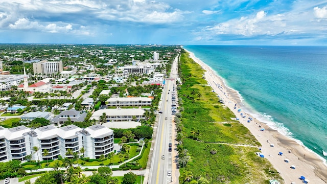 drone / aerial view with a water view and a beach view