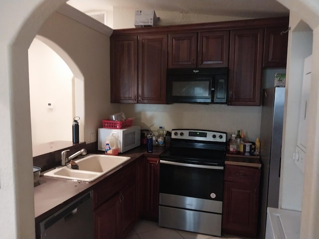 kitchen with black appliances, dark brown cabinetry, sink, and light tile patterned floors