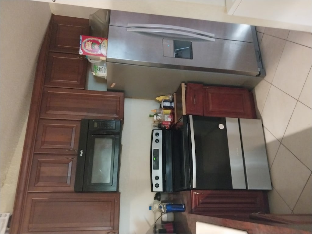 kitchen featuring stainless steel refrigerator and tasteful backsplash