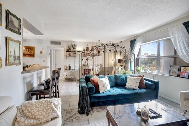 living room featuring light tile patterned flooring and a textured ceiling
