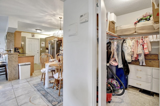 spacious closet with light tile patterned floors