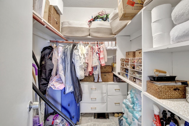 spacious closet with light tile patterned floors