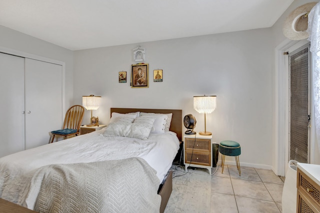 tiled bedroom featuring a closet