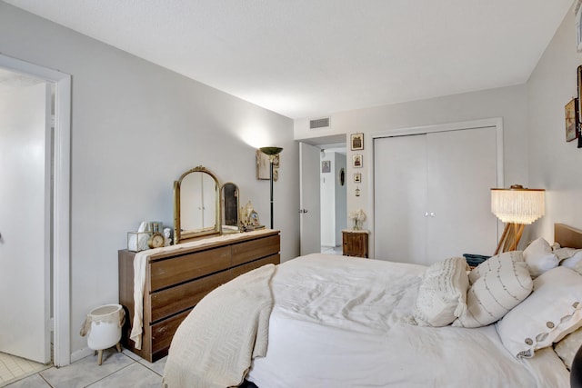 tiled bedroom featuring a closet