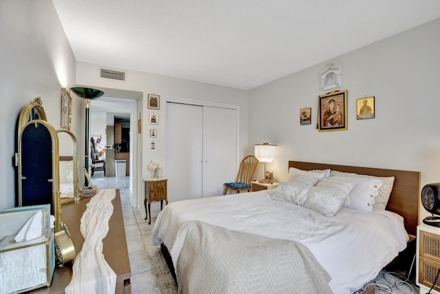 tiled bedroom with a closet