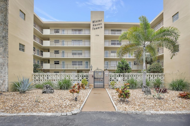 view of apartment building / complex with fence
