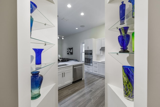 kitchen featuring white cabinetry, appliances with stainless steel finishes, sink, and light wood-type flooring