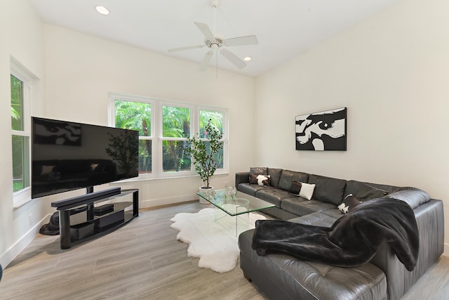 living room with light hardwood / wood-style floors and ceiling fan