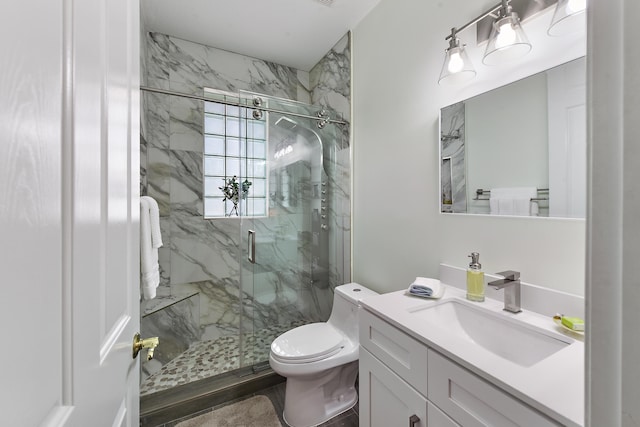 bathroom featuring vanity, toilet, and a shower with shower door