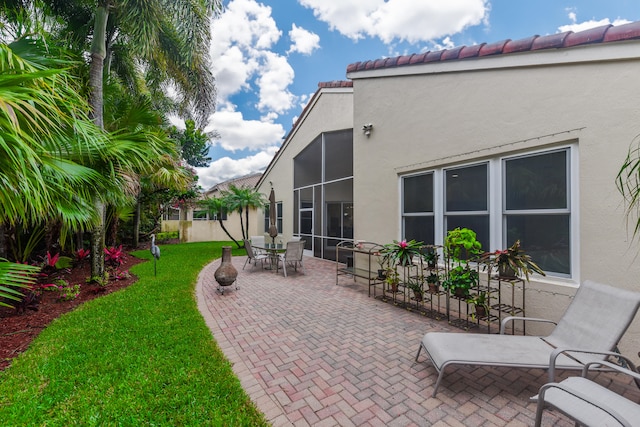 view of patio / terrace with a sunroom