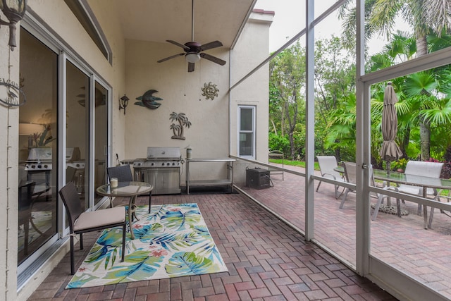 sunroom with a wealth of natural light and ceiling fan