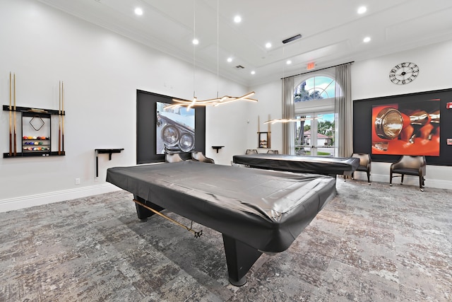 game room with pool table, crown molding, and a towering ceiling