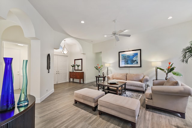 living room featuring light hardwood / wood-style flooring and ceiling fan