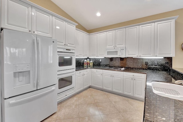 kitchen featuring backsplash, white cabinetry, sink, white appliances, and lofted ceiling