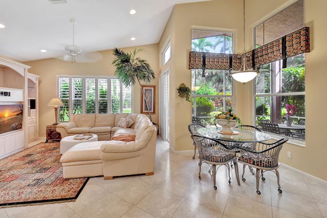 living room with light tile patterned floors, ceiling fan, and plenty of natural light