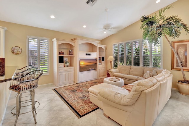 living room featuring built in shelves, ceiling fan, lofted ceiling, and light tile patterned flooring