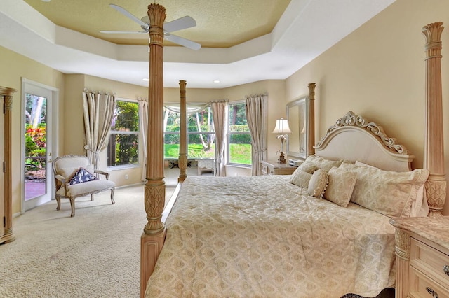 bedroom with multiple windows, light carpet, and access to outside