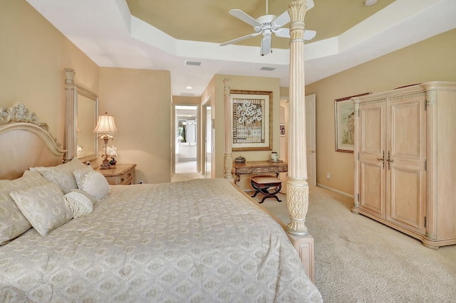 bedroom featuring light carpet, ceiling fan, and a raised ceiling