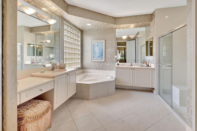 bathroom featuring independent shower and bath, tile patterned flooring, and vanity