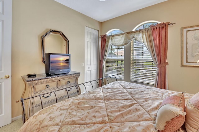 bedroom featuring light colored carpet